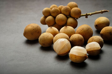 Longkong, tropical fruit on dark background.