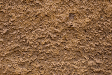 Old retro scrutched yellow brown plaster stucco wall texture