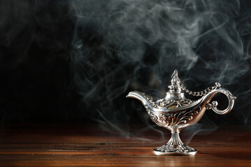 Magic lamp on a wooden table in the dark night 