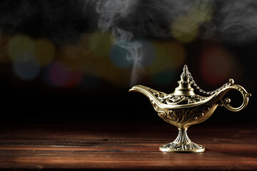 Magic lamp on a wooden table in the dark night 