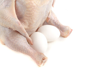 Fresh raw chicken and two eggs. Isolated on a white background. Cutting off the path.