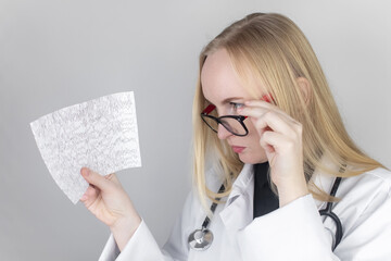 A neurologist examines an encephalogram of a patient’s brain. Schedule of electroencephalograms -...