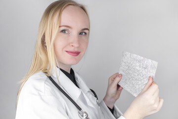 A neurologist examines an encephalogram of a patient’s brain. Schedule of electroencephalograms -...
