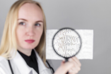 A neurologist with a magnifying glass examines an encephalogram of a patient’s brain. Schedule of...