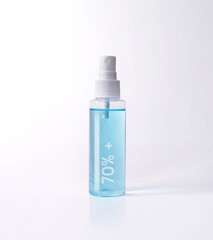 Blue alcohol 70%+ bottle spray isolated with clipping path. Covid-19 concept.