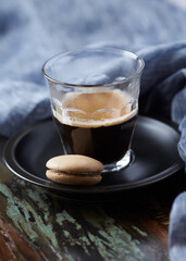 Coffee in glass cup on rustic wooden background. Close up.	