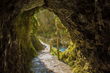 The footpath along the Tolminka River which flows through Tolmin Gorge cuts through a rock tunnel in the Triglav National Park, north western Slovenia
