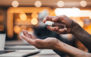 close up. man spraying antiseptic hand spray.