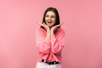 Photo of attractive woman in glasses smile surprised and wonder wear casual pink t-shirt white pants isolated pink color background