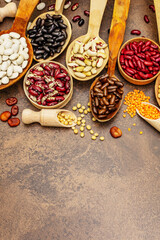 Set of various dry legumes in wooden spoons as indispensable protein for a healthy life