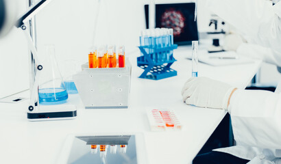 digital tablet and ampoules with the vaccine on the table in the laboratory.