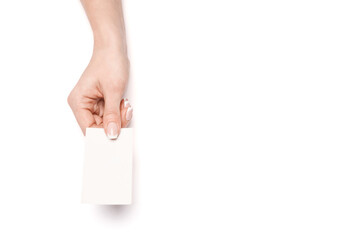 Female hand holding a blank business card over white background