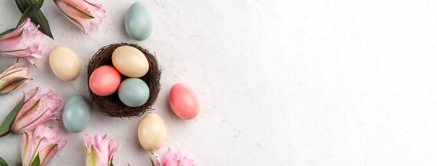 Colorful Easter eggs in the nest with pink Double Lily flower.