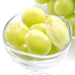 Beautiful Shine Muscat green grape in a glass cup isolated on white background.