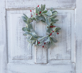 Lamb's Ear with red berries wreath on white antique door © Tracy
