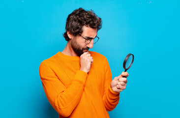 young bearded man with a magnifying glass