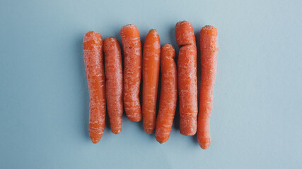 orange food background. close-up of vertically carrots on blue. Bunch of orange organic carrots. natural vegetable food just harvested. colorful food