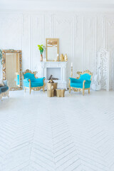 Luxury light interior of living room with gold wall and chic expensive furniture in white and gold colors