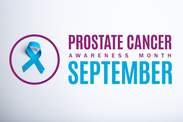 Prostate cancer awareness mont. September. Blue handmade awareness paper ribbon on white background.