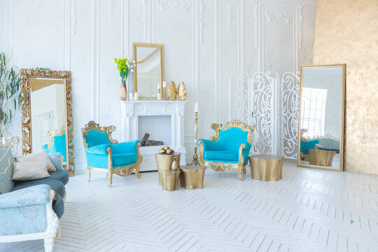 Luxury light interior of living room with gold wall and chic expensive furniture in white and gold colors © 4595886