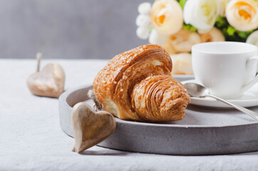 Morning  romantic coffee, croissant on light grey tray for Valentine romantic gift concept.