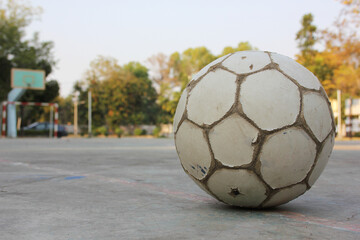 Fototapeta na wymiar An old soccer ball in the field