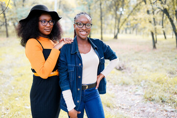 two african american sisters women having fun in the park outdoors