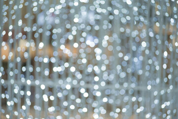 Christmas light background. Holiday glowing backdrop. Defocused Background With Blinking Stars. Blurred Bokeh.