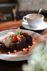 Chocolate cake with ice cream and coffee dessert on wood table