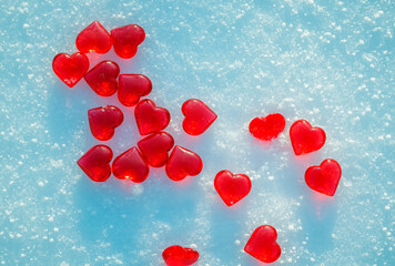 valentine's day greeting card with festive background with transparent red love symbols hearts on blue snow