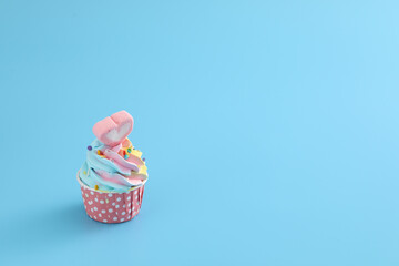 Colorful cupcake isolated in blue background