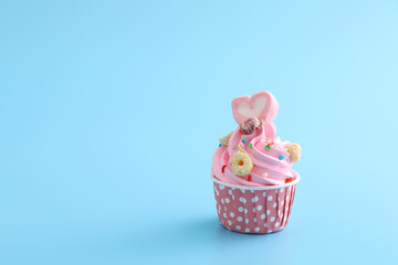 pink cupcake isolated in blue background