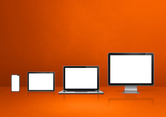 computer, laptop, mobile phone and digital tablet pc. orange background
