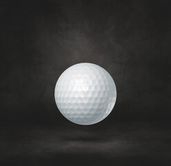 White golf ball on a black studio background