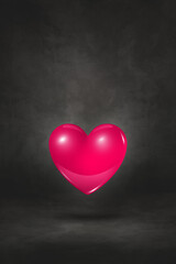 3D pink heart on a black studio background