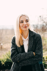 Portrait of a young blonde woman on sunny spring day.