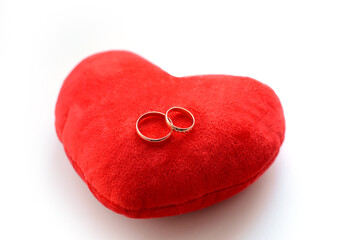 Wedding rings on a red heart