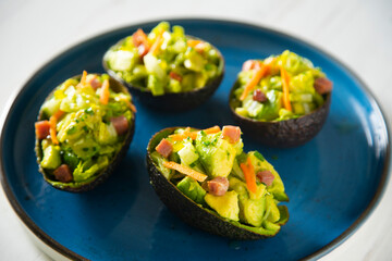 Avocado stuffed with salad. Super food vegan recipe.