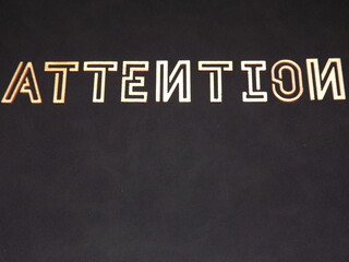 The word Attention is made of wooden letters on colorful backgrounds. High quality photo