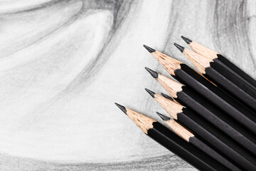 top view of set of black graphite pencils on hand-drawn academic drawing close up