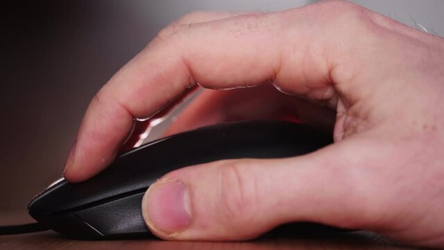 Human Hand Scrolling Up On The Mouse Cursor And Clicks On Left Button. close up
