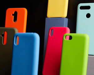 colorful cases for modern smartphones stand on stands on the table one object in focus blurred background