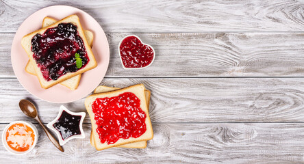 Delicious toasts with various sweet jams on grey background. Copyspace for your text, banner. - 409042526