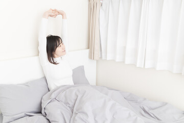 Fototapeta na wymiar Woman waking up in bed