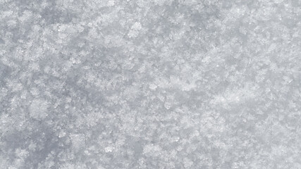 Frozen textured snow surface with ice crystals.
