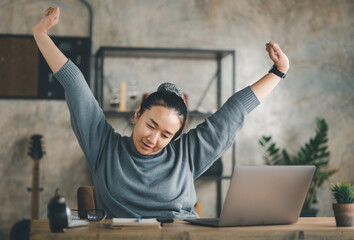 Young Asian Business woman stretching herself and exercise for relaxation while working at home...