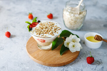 A dietary dessert made from oatmeal and fresh strawberries. Delicious healthy, light breakfast. Panna Cotta. Granola with yoghurt. The right sweets. Vegetarian sweets
