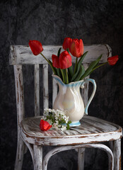 Obraz na płótnie Canvas Red tulips bouquet in white vase on vintage cher. Valentine Day, Mothers day, birthday concept.