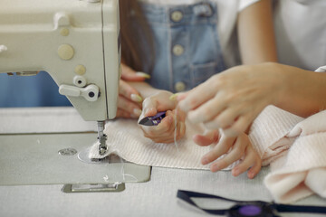 Mother with daughter at the factory. Family with a fabric.