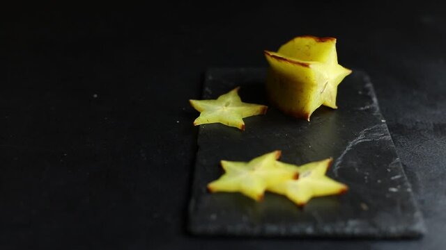carambola star fruit cut into slices on the table for healthy meal snack outdoor top view copy space for text food background rustic